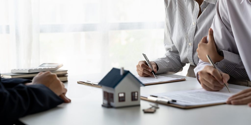 Real estate agent closing a deal with a couple